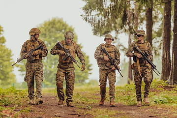 Image showing Soldier fighters standing together with guns. Group portrait of US army elite members, private military company servicemen, anti terrorist squad