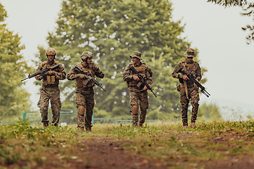 Image showing Soldier fighters standing together with guns. Group portrait of US army elite members, private military company servicemen, anti terrorist squad