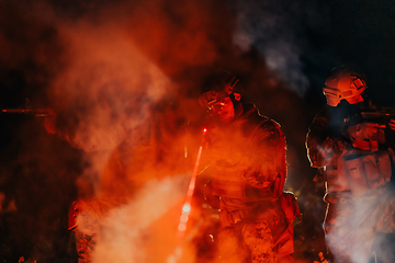 Image showing Soldiers squad in action on night mission using laser sight beam lights military team concept