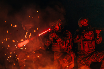 Image showing Soldiers squad in action on night mission using laser sight beam lights military team concept