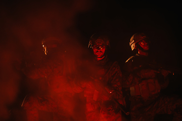 Image showing Soldiers squad in action on night mission using laser sight beam lights military team concept