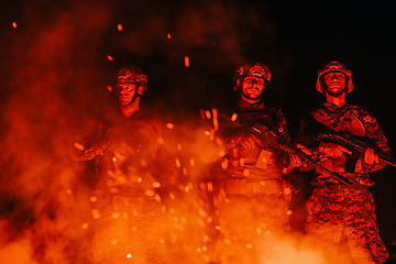 Image showing Soldiers squad in action on night mission using laser sight beam lights military team concept