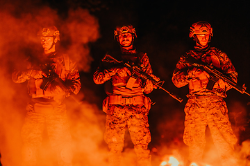 Image showing Soldiers squad in action on night mission using laser sight beam lights military team concept