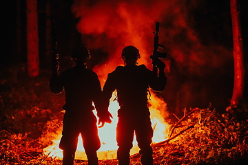 Image showing Special marines military forces squad soldiers group portrait after finished mission complete fire in background