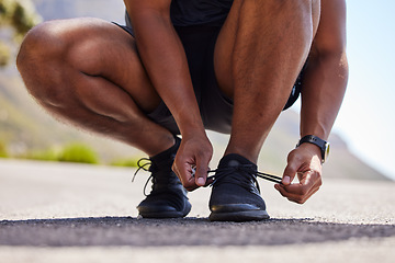 Image showing Running, hands or person on road with shoes for fitness exercise, workout and marathon training. Closeup, tying lace or athlete runner ready to run, walk or jog with sneakers, trainers or footwear