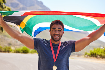 Image showing Runner, success and portrait of happy man with flag on road for fitness goal, winning or running race. Sports champion, winner or proud South African or excited athlete with victory or gold medal