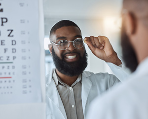 Image showing Eye exam, smile and optometrist or man with glasses, confidence and happy service in consultation office. Ophthalmology, face in mirror and expert in vision, test or assessment for eyes or health