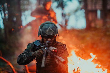 Image showing A soldier fights in a warforest area surrounded by fire