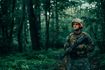 Image showing A modern warfare soldier on war duty in dense and dangerous forest areas. Dangerous military rescue operations