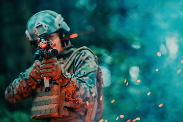 Image showing A soldier fights in a warforest area surrounded by fire