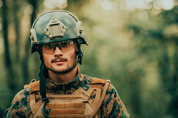 Image showing Soldier portrait with protective army tactical gear and weapon having a break and relaxing