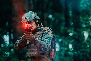 Image showing A soldier fights in a warforest area surrounded by fire