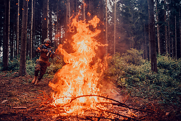 Image showing Modern warfare soldiers surrounded by fire fight in dense and dangerous forest areas