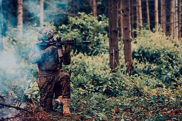 Image showing A soldier fights in a warforest area surrounded by fire