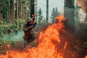 Image showing Modern warfare soldier surrounded by fire, fight in dense and dangerous forest areas