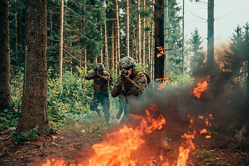 Image showing Modern warfare soldiers surrounded by fire fight in dense and dangerous forest areas