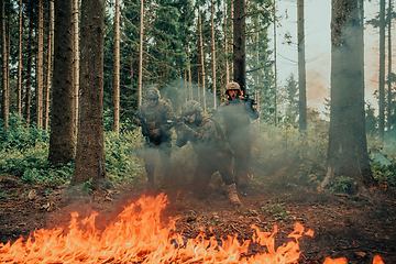 Image showing Modern warfare soldiers surrounded by fire fight in dense and dangerous forest areas