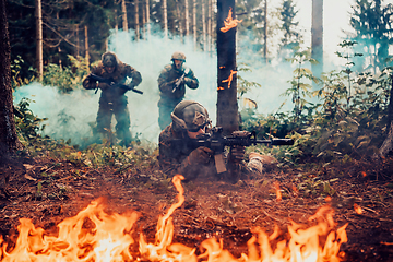 Image showing Modern warfare soldiers surrounded by fire fight in dense and dangerous forest areas