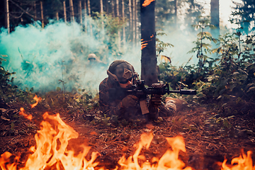 Image showing Modern warfare soldier surrounded by fire, fight in dense and dangerous forest areas