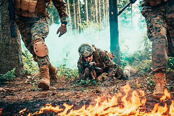 Image showing Modern warfare soldiers surrounded by fire fight in dense and dangerous forest areas