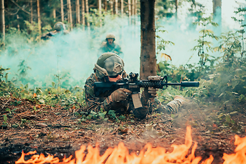 Image showing Modern warfare soldiers surrounded by fire fight in dense and dangerous forest areas