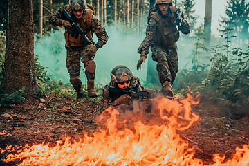 Image showing Modern warfare soldiers surrounded by fire fight in dense and dangerous forest areas