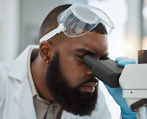 Image showing Science, microscope and a man in a laboratory for medical research, study or analysis. Face of a black male person or scientist with a scope for innovation, biotechnology and future development
