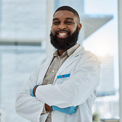 Image showing Black man, doctor and portrait with arms crossed in hospital for healthcare services, surgery and consulting in Nigeria. Happy surgeon, therapist and medical professional working with trust in clinic