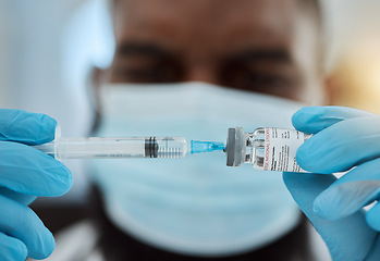 Image showing Medicine, vaccine and a doctor man with a syringe and mask for virus, health care and cure in hospital. Hands of person with a pharmaceutical product, vial or container for treatment or injection