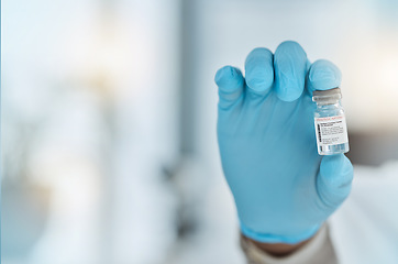 Image showing Vaccine, medicine and hand of a doctor with gloves for virus protection, health care and cure in hospital. Person with a pharmaceutical product, vial or container for treatment or prevention space