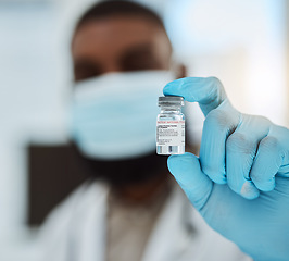 Image showing Medicine, vaccine and a hand of a doctor with gloves for virus protection, healthcare or cure in hospital. Person with pharmaceutical product, vial or container for treatment, solution or prevention