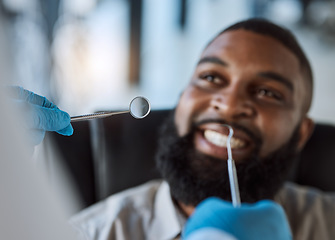 Image showing Man, hands and dentist tools for cleaning in clinic for medical treatment, teeth whitening or veneer hygiene. Smile, mirror and dental excavator for African patient in mouth health checkup or consult