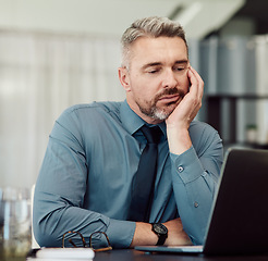 Image showing Tired, bored and business man with laptop in office, stress or problem in company. Computer, sad and mature manager with challenge, fatigue and financial crisis, debt email and burnout for tax audit