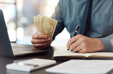 Image showing Hands, money and saving with writing, book and accounting for audit, balance and financial review in workplace. Man, pen and notebook with cash, bills and budget for small business, investing or goal