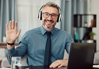 Image showing Portrait, headphones and man wave on video call for business smile in online chat at home. Happy face, hello and webinar of mature manager with glasses in virtual meeting for remote work on laptop