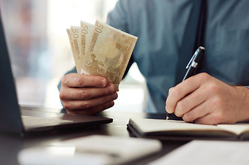 Image showing Hands, money and writing in office, book and accounting for audit, balance and financial review in workplace. Man, pen and notebook with cash, bills and budget for small business, investing or saving