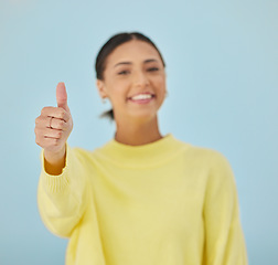 Image showing Happy woman, portrait and thumbs up for good job, approval or winning against a studio background. Female person smile with like emoji, yes sign or OK for agreement, thank you or positive feedback