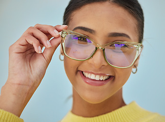 Image showing Woman portrait, glasses and vision with blue light frame with a smile with ophthalmology. Isolated, studio background and happy person with eye care, wellness and health of a girl with eyewear