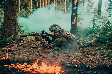 Image showing Modern warfare soldier surrounded by fire, fight in dense and dangerous forest areas