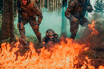 Image showing Modern warfare soldiers surrounded by fire fight in dense and dangerous forest areas