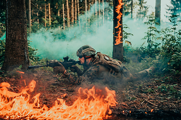 Image showing Modern warfare soldier surrounded by fire, fight in dense and dangerous forest areas