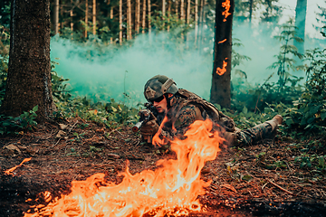 Image showing Modern warfare soldiers surrounded by fire fight in dense and dangerous forest areas