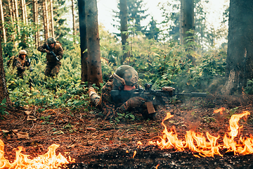 Image showing Modern warfare soldiers surrounded by fire fight in dense and dangerous forest areas