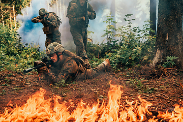 Image showing Modern warfare soldiers surrounded by fire fight in dense and dangerous forest areas