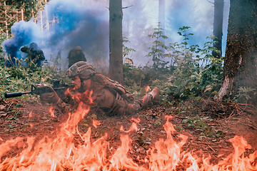 Image showing Modern warfare soldiers surrounded by fire fight in dense and dangerous forest areas