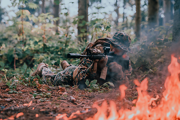 Image showing A soldier fights in a warforest area surrounded by fire