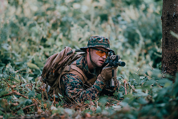 Image showing Modern warfare soldier surrounded by fire, fight in dense and dangerous forest areas