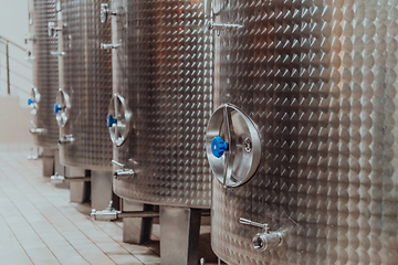 Image showing Modern wine distillery and brewery with brew kettles pipes and stainless steel tanks