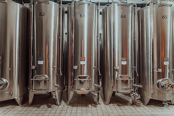 Image showing Modern wine distillery and brewery with brew kettles pipes and stainless steel tanks