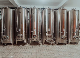 Image showing Modern wine distillery and brewery with brew kettles pipes and stainless steel tanks